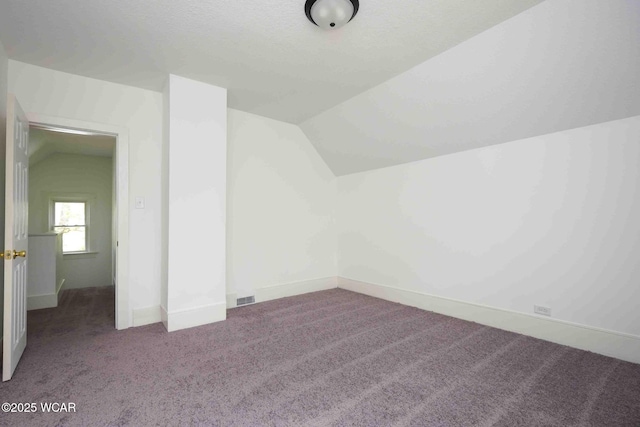 bonus room featuring carpet, lofted ceiling, and baseboards
