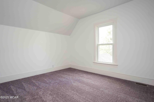 bonus room featuring lofted ceiling and carpet floors