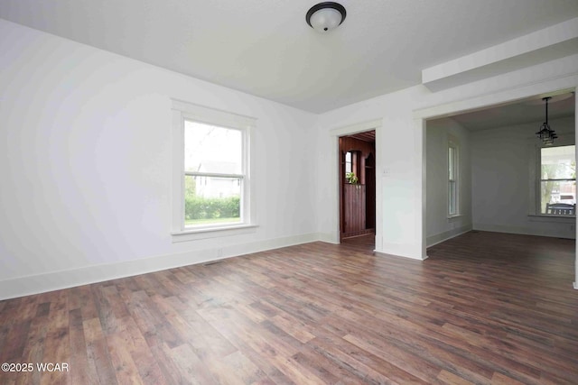 unfurnished room with wood finished floors and baseboards