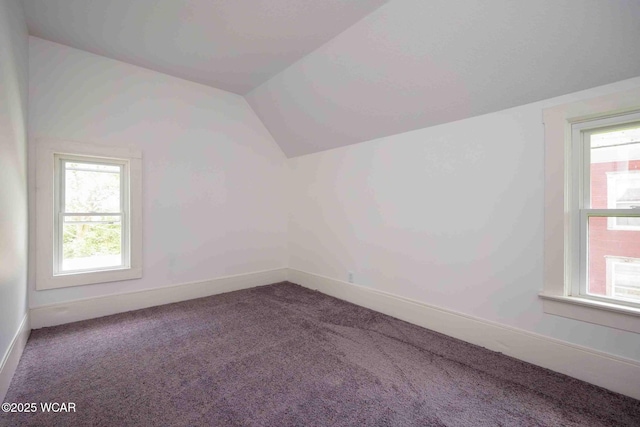 bonus room with vaulted ceiling, carpet, plenty of natural light, and baseboards