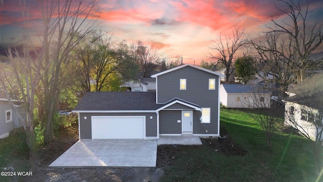 view of front of property with a garage and a yard