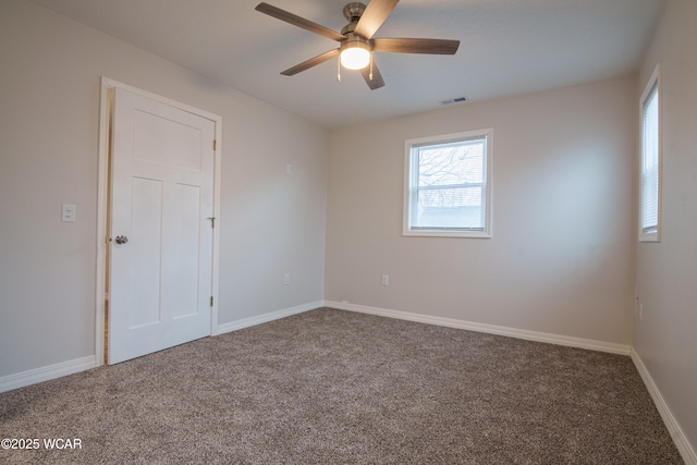 unfurnished room featuring ceiling fan and carpet floors