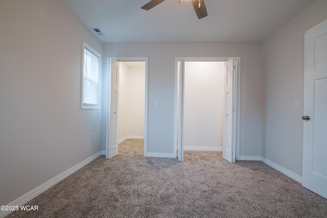 unfurnished bedroom featuring ceiling fan and light carpet