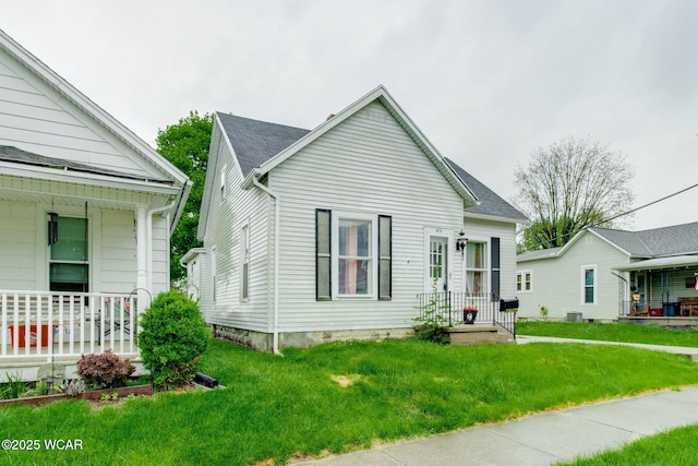 608 W Pearl St, Wapakoneta, OH 45895 - view of front of property with a front lawn, cooling unit, and covered porch