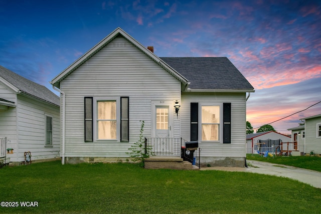 608 W Pearl St, Wapakoneta, OH 45895 - view of front of house featuring a front lawn and a shingled roof
