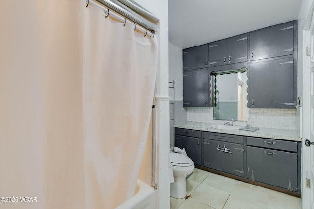 608 W Pearl St, Wapakoneta, OH 45895 - bathroom with toilet, shower / tub combo with curtain, tile patterned floors, vanity, and backsplash