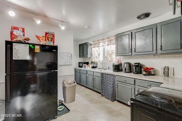 608 W Pearl St, Wapakoneta, OH 45895 - kitchen with a sink, gray cabinets, black appliances, backsplash, and light countertops