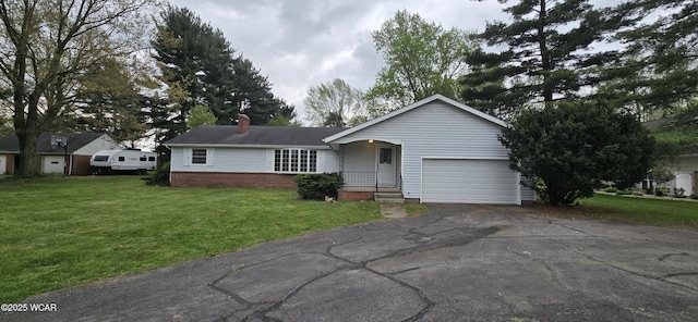 single story home featuring driveway, a chimney, a front lawn, and a garage