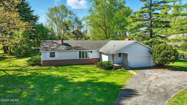 2971 Ft Amanda Rd, Lima, OH 45805 - single story home featuring driveway, a chimney, a front lawn, and a garage