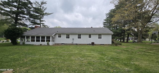 2971 Ft Amanda Rd, Lima, OH 45805 - back of house featuring a lawn, central AC, a chimney, and a sunroom