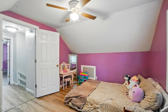 bedroom with vaulted ceiling, wood finished floors, and a ceiling fan