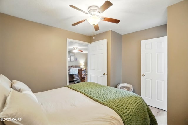 bedroom featuring a ceiling fan and wood finished floors