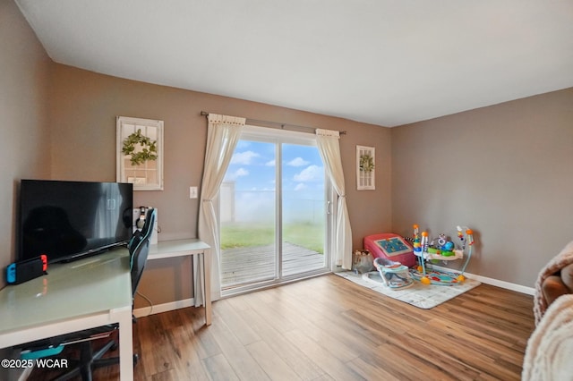 interior space featuring wood finished floors and baseboards