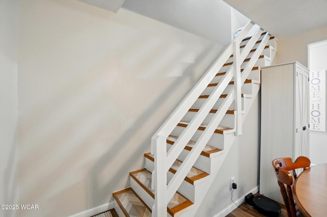 stairway with wood finished floors