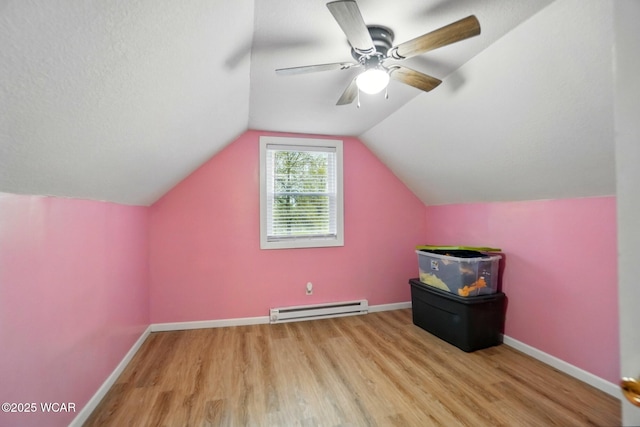 bonus room with lofted ceiling, baseboards, baseboard heating, and wood finished floors