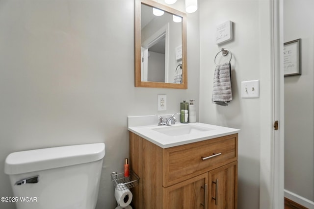 bathroom featuring toilet and vanity
