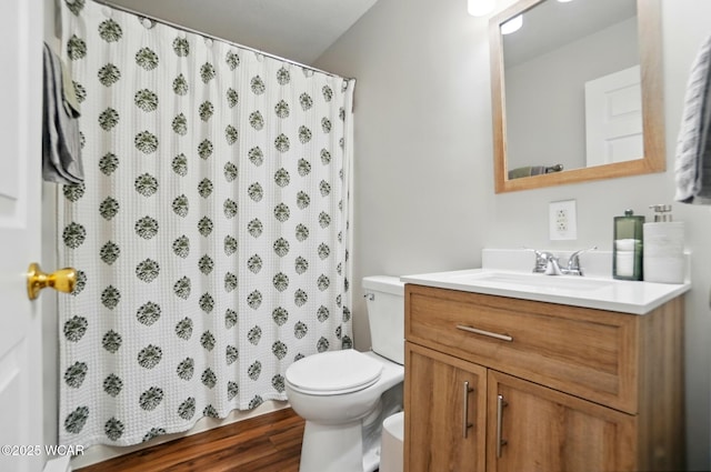 full bath featuring toilet, a shower with shower curtain, wood finished floors, and vanity