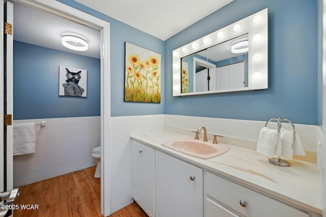 3A Mews Rd, Lima, OH 45805 - bathroom with vanity, tile walls, wood finished floors, and a wainscoted wall