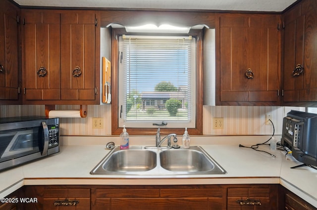1317 Larry St, Van Wert, OH 45891 - kitchen with stainless steel microwave, light countertops, and healthy amount of natural light