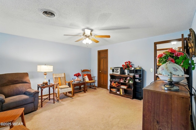 1317 Larry St, Van Wert, OH 45891 - living area with light carpet, ceiling fan, and a textured ceiling