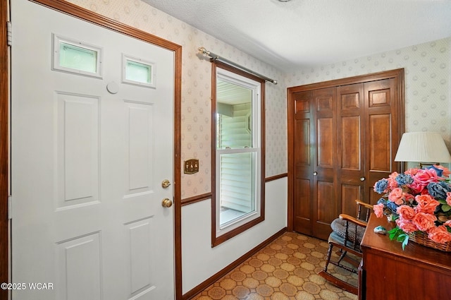 1317 Larry St, Van Wert, OH 45891 - foyer entrance with wallpapered walls, tile patterned floors, and a textured ceiling