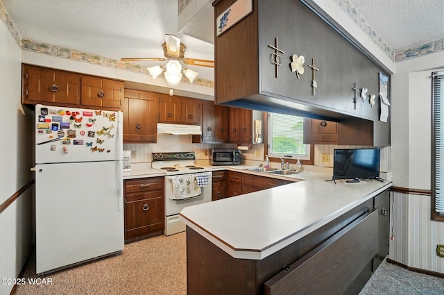 1317 Larry St, Van Wert, OH 45891 - kitchen with white appliances, under cabinet range hood, a textured ceiling, wallpapered walls, and light countertops