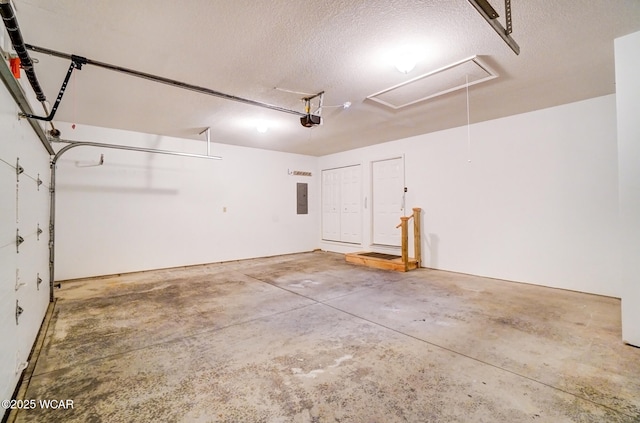 garage with electric panel and a garage door opener