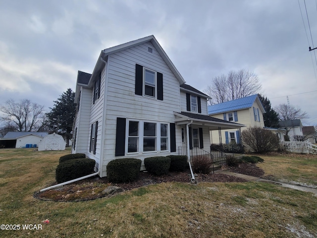 view of property with a front yard and covered porch