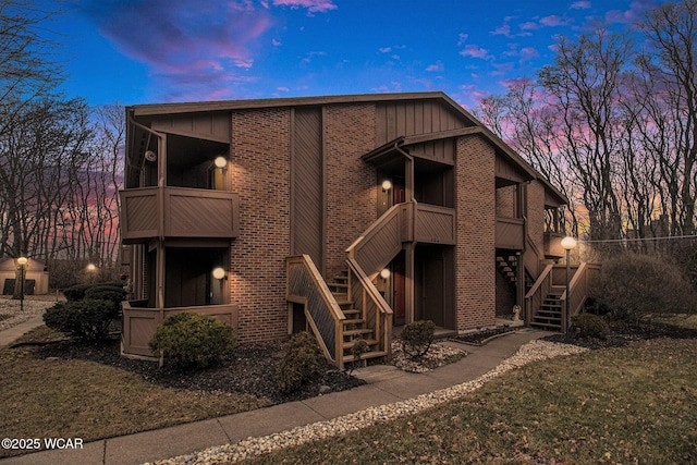 exterior space with brick siding and stairway