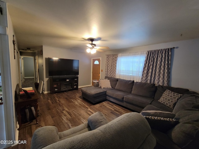 living area featuring ceiling fan, baseboards, and wood finished floors