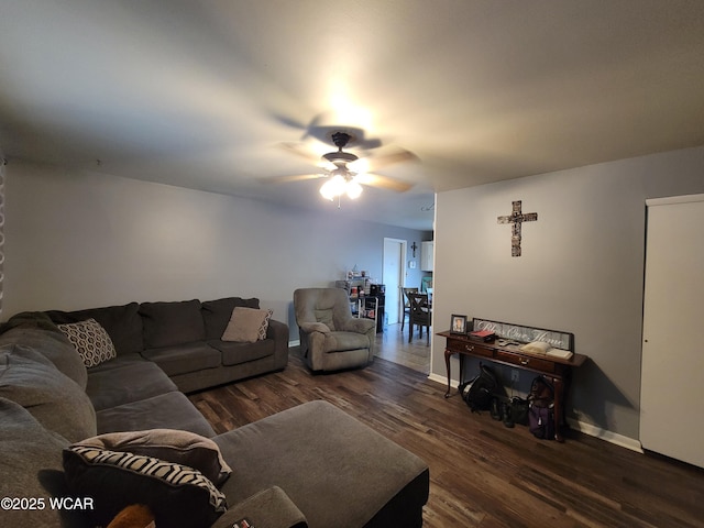 living room with dark wood finished floors, baseboards, and ceiling fan