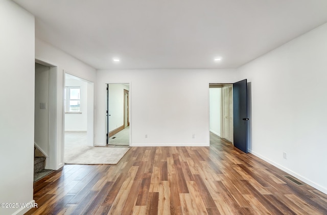 spare room with wood-type flooring