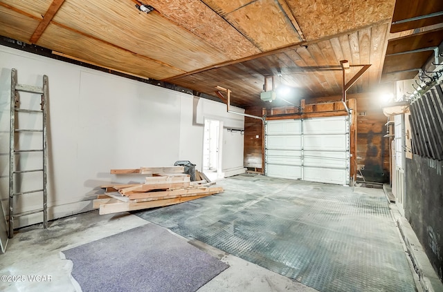 garage featuring a garage door opener and wooden ceiling