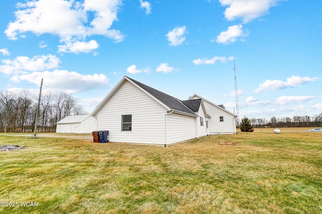 view of side of home with a yard