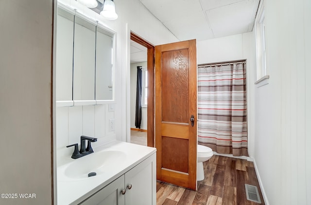 bathroom with vanity, wood-type flooring, toilet, and walk in shower