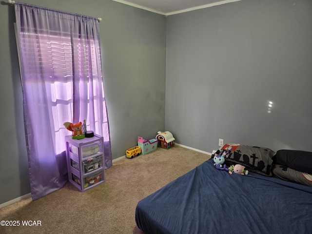 bedroom with crown molding and carpet flooring