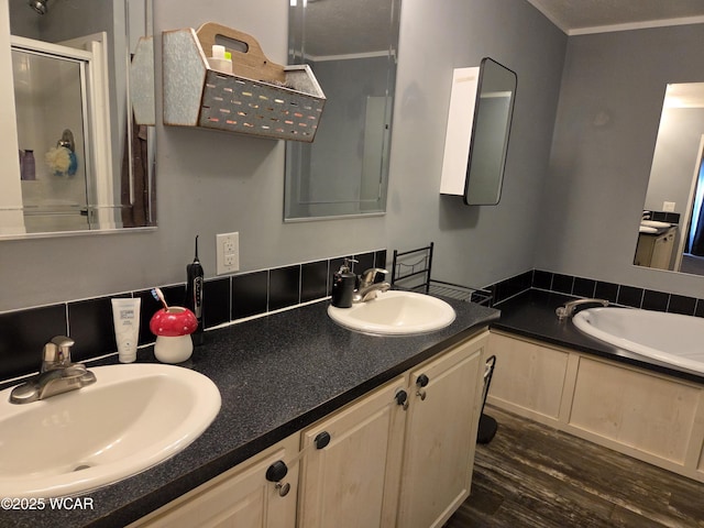 bathroom featuring wood-type flooring, an enclosed shower, and vanity