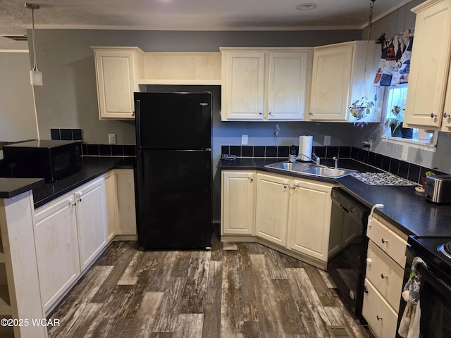 kitchen featuring pendant lighting, dark wood-type flooring, sink, and black appliances