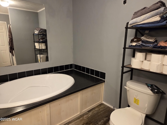 bathroom featuring crown molding, hardwood / wood-style flooring, and toilet