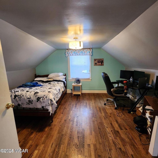 bedroom with lofted ceiling and dark wood-type flooring