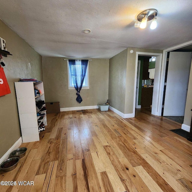 interior space featuring hardwood / wood-style floors and a textured ceiling