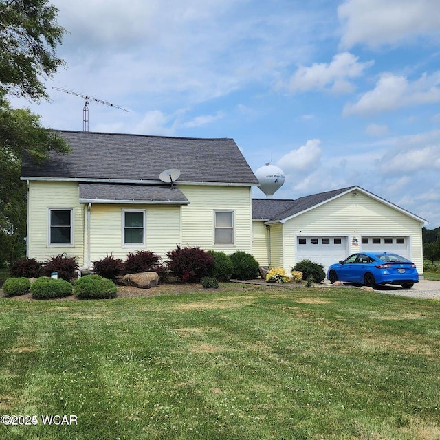 view of front of home with a garage and a front yard