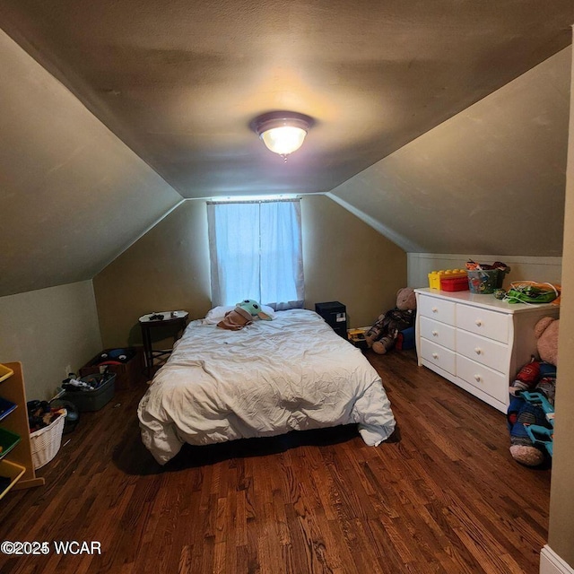 bedroom featuring dark wood-type flooring and vaulted ceiling