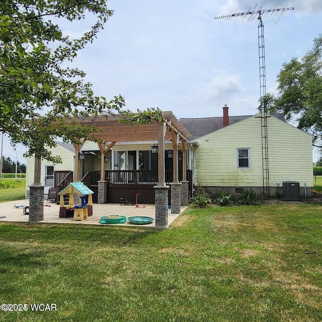 back of property featuring a patio, a yard, central AC unit, and a pergola