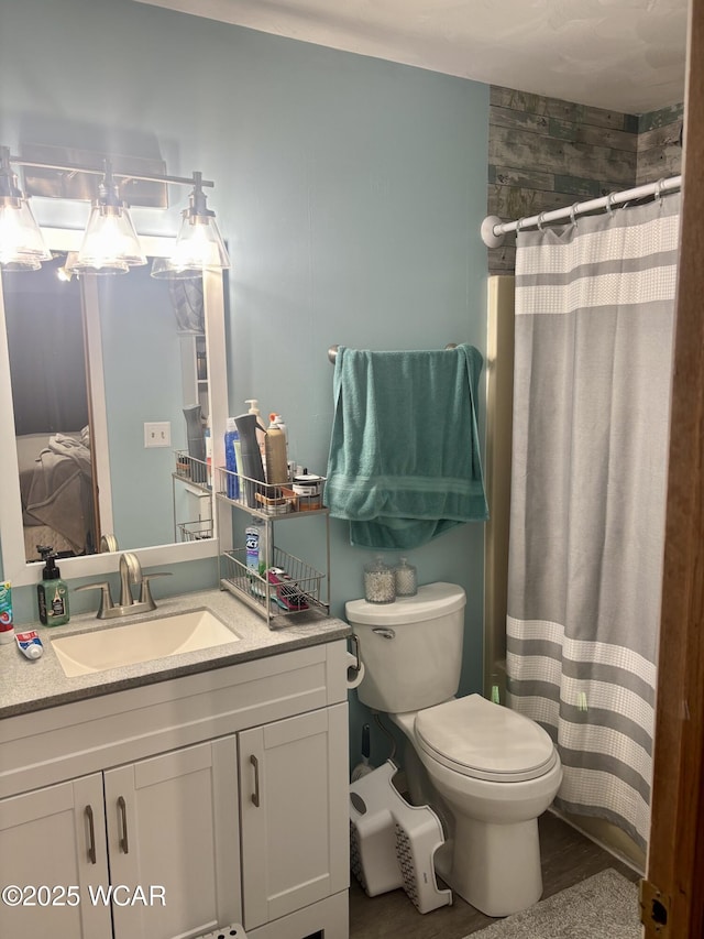 bathroom with vanity, toilet, and a shower with shower curtain