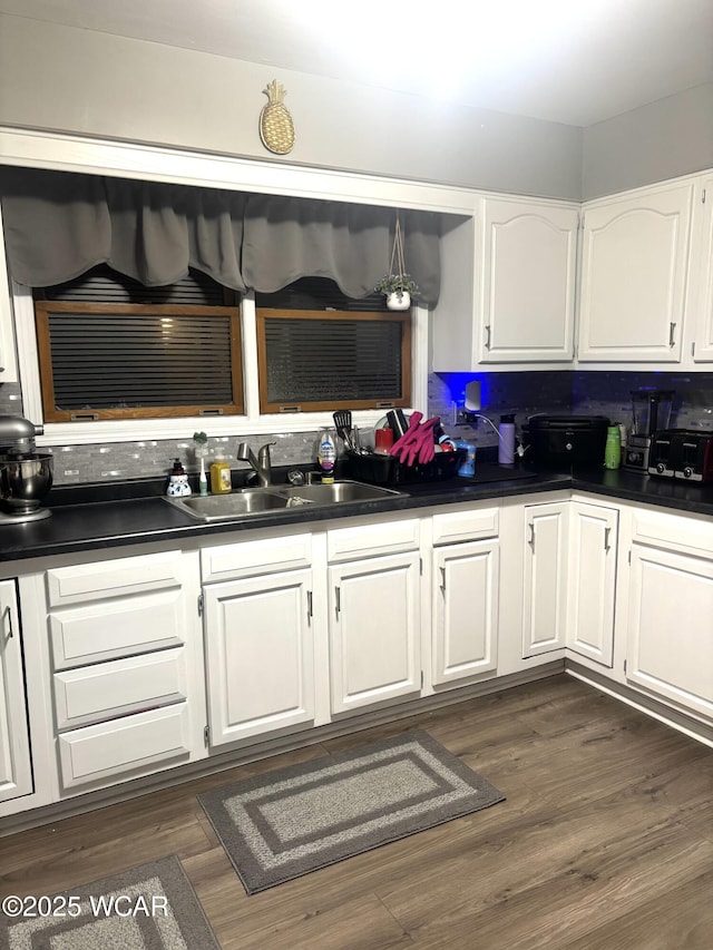 kitchen featuring white cabinetry, sink, and dark wood-type flooring