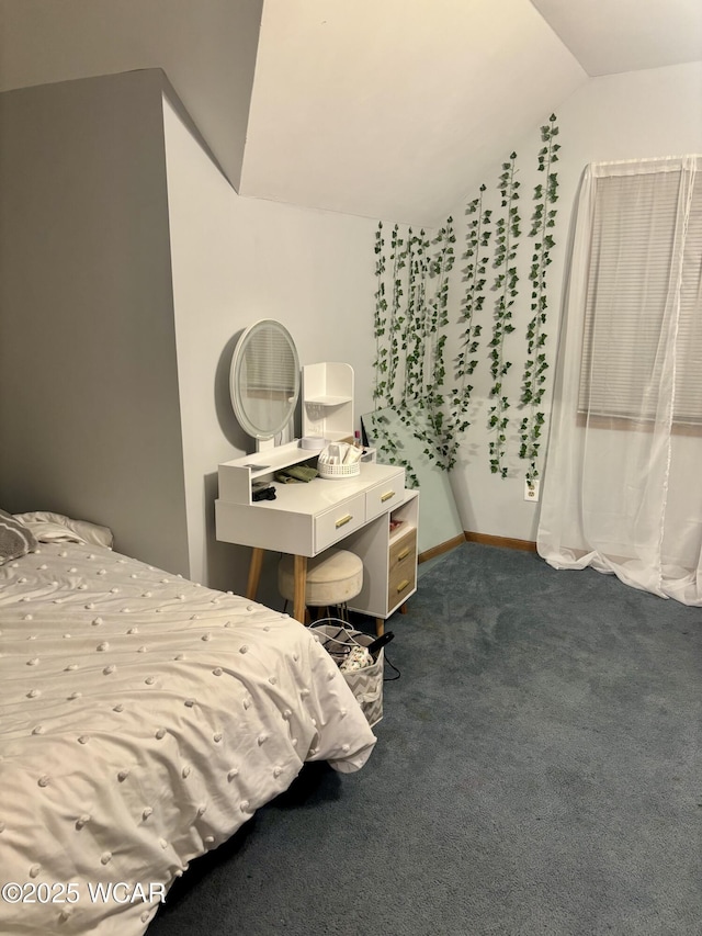 bedroom with lofted ceiling and dark carpet