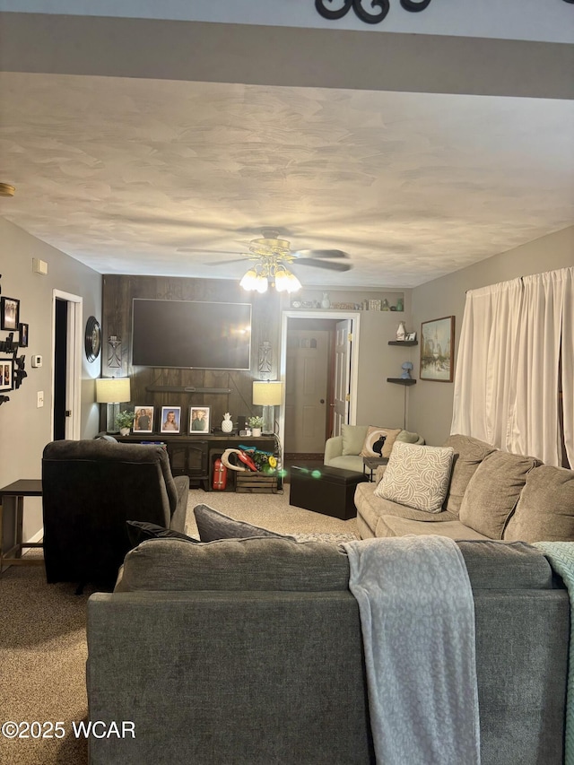 carpeted living room with ceiling fan