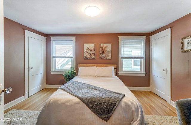 bedroom featuring light wood-style floors and baseboards