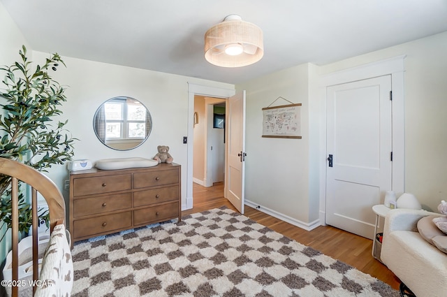 bedroom featuring baseboards and wood finished floors